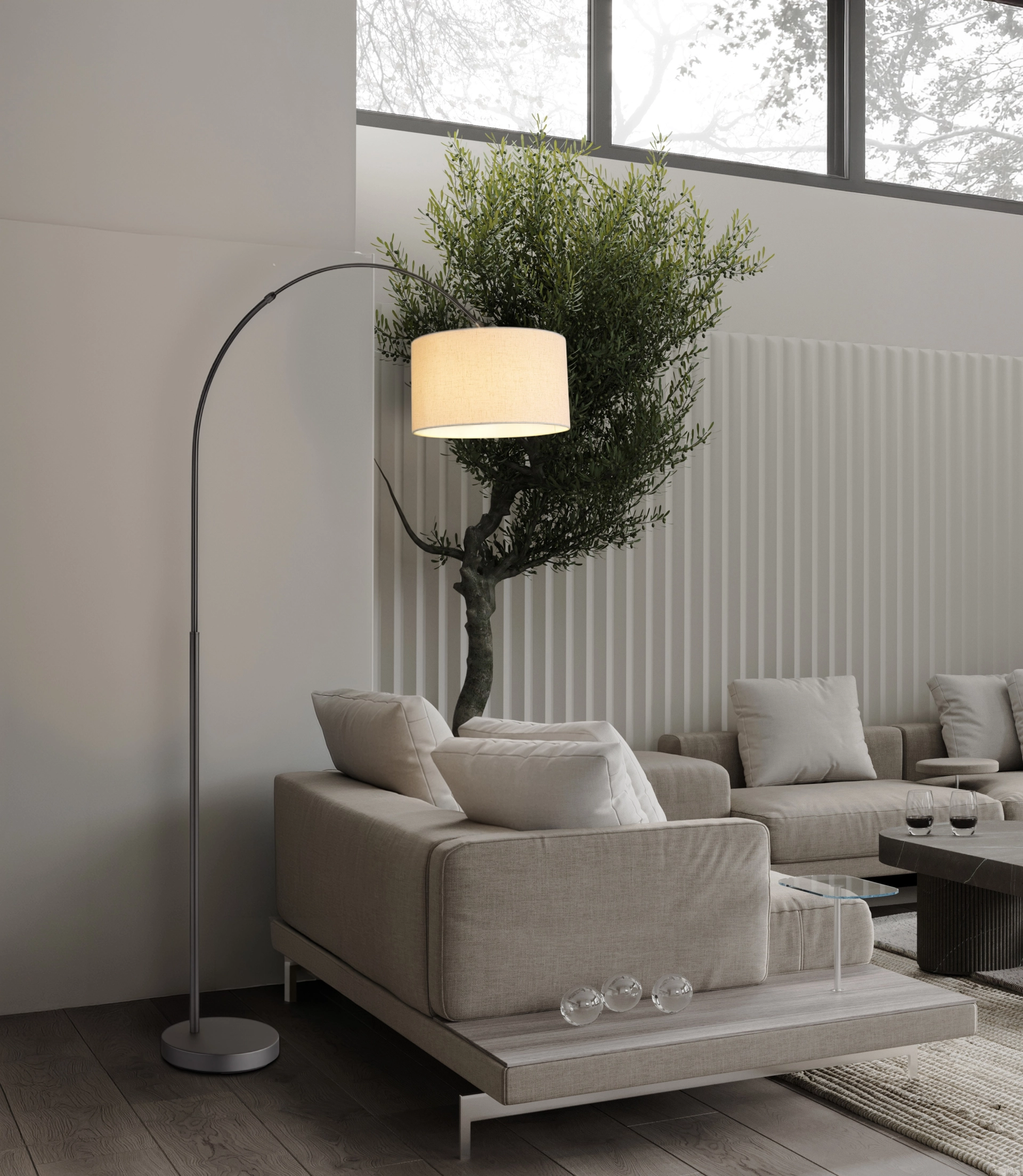 Lampadaire THEA avec structure courbée en métal noir chrome mat et abat-jour cylindrique en lin crème, près d’un canapé dans un salon moderne ; Globo Handels GmbH, réf. 43540108